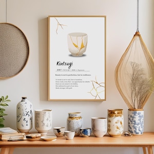 May include: A white ceramic teacup with gold cracks, known as Kintsugi, is shown on a white background with the text "Kintsugi 金継ぎ / kintsugi / noun - Japanese Beauty is not in perfection, but in resilience. To break is not to end, but to transform. Every crack, every flaw-an opportunity for rebirth Scars are not meant to be hidden, But embraced as part of our story, Made stronger with gold."