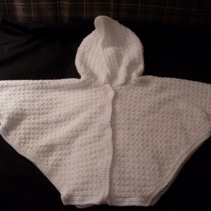 Hand crocheted girl&#39;s white buttoned cape