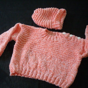 Hand knit orange and white pullover sweater and hat