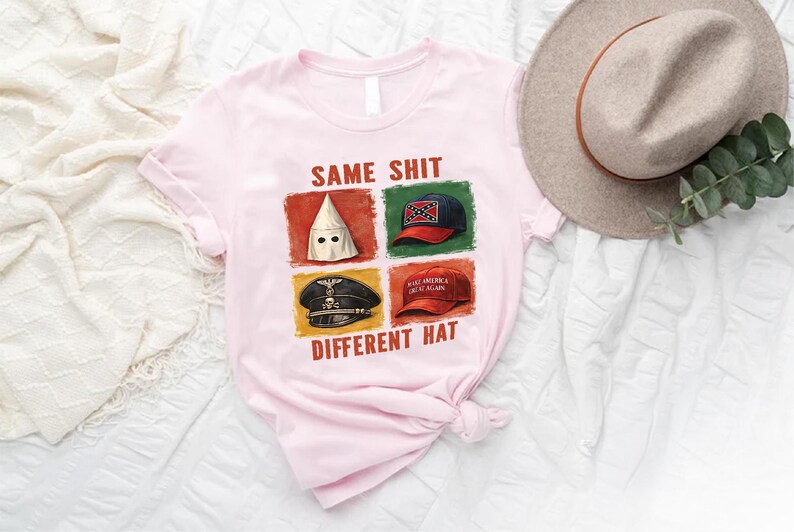 May include: Light pink t-shirt with the text "SAME SHIT DIFFERENT HAT" and four images of hats. A tan hat and greenery are in the background.