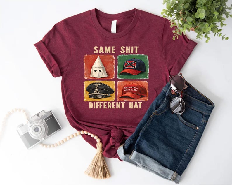 May include: Maroon t-shirt with the text "SAME SHIT DIFFERENT HAT" and four images of different hats. The shirt is paired with blue denim shorts and sunglasses. A camera and decorative beads are also in the image.