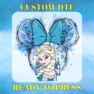 May include: A blue and white polka dot bow with a sketch of a Disney princess with blonde hair and a blue dress. The text "CUSTOM DTF" and "READY TO PRESS" is included in the image.