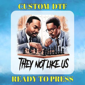 May include: A digital graphic featuring two men playing chess. The image includes the text "CUSTOM DTF", "THEY NOT LIKE US", and "READY TO PRESS" in yellow and black. The chess pieces are black and white.