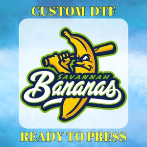 May include: A graphic transfer featuring a yellow banana character holding a baseball bat with the text SAVANNAH BANANAS in white and dark blue. The top text reads CUSTOM DTF and the bottom text reads READY TO PRESS on a light blue background.