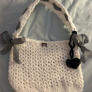 White Coquette Crocheted Stretchy Mesh Hand/ Shoulder Bag With Heart Charm and Black Gingham Bow Ribbon
