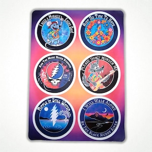 May include: A set of six circular stickers with various designs and text. The designs include a mouse, a peace sign, a skull, a wolf playing guitar, a lightning bolt, and a mountain scene. The text includes phrases like "I Need a Miracle" and "Please Don't Murder Me."