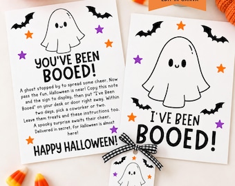 May include: Two white rectangular cards and one small tag featuring black ghost illustrations, bats, and orange and purple stars. The text reads YOU'VE BEEN BOOED! and I'VE BEEN BOOED! with instructions for a Halloween office game. A black and white gingham ribbon is attached to the tag.