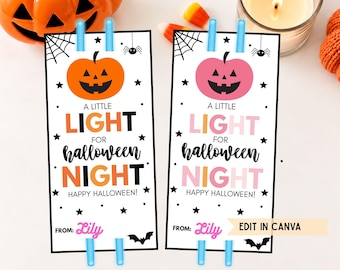 May include: Two rectangular paper tags featuring a jack-o'-lantern graphic, black stars, a spider web, and a spider. The text reads: A LITTLE LIGHT FOR HALLOWEEN NIGHT HAPPY HALLOWEEN! FROM: Lily. One tag has orange accents, the other has pink accents.