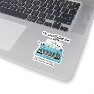 May include: A sticker featuring a light blue typewriter with the text "DOCUMENTATION SHE WROTE." The sticker also includes the text "SOLVING MEDICAL MYSTERIES WITH A CODE BOOK AND A PEN."