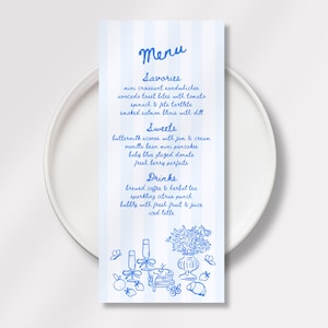 May include: A menu card with a blue and white striped background, featuring a handwritten menu in blue ink. The menu lists savories, sweets, and drinks. The card is placed on a white plate, with illustrations of food and drinks at the bottom.