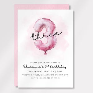 May include: A pink birthday invitation with a watercolor-style number three balloon. The word "three" is written in cursive above the balloon. The invitation includes details for Vivienne's 3rd birthday, including the date, time, and location.
