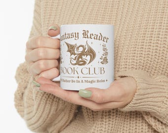 May include: White ceramic mug featuring the text "Fantasy Reader Book Club" in a decorative font, along with a golden dragon illustration. The mug also includes the phrase "I'd Rather Be In A Magic Realm".