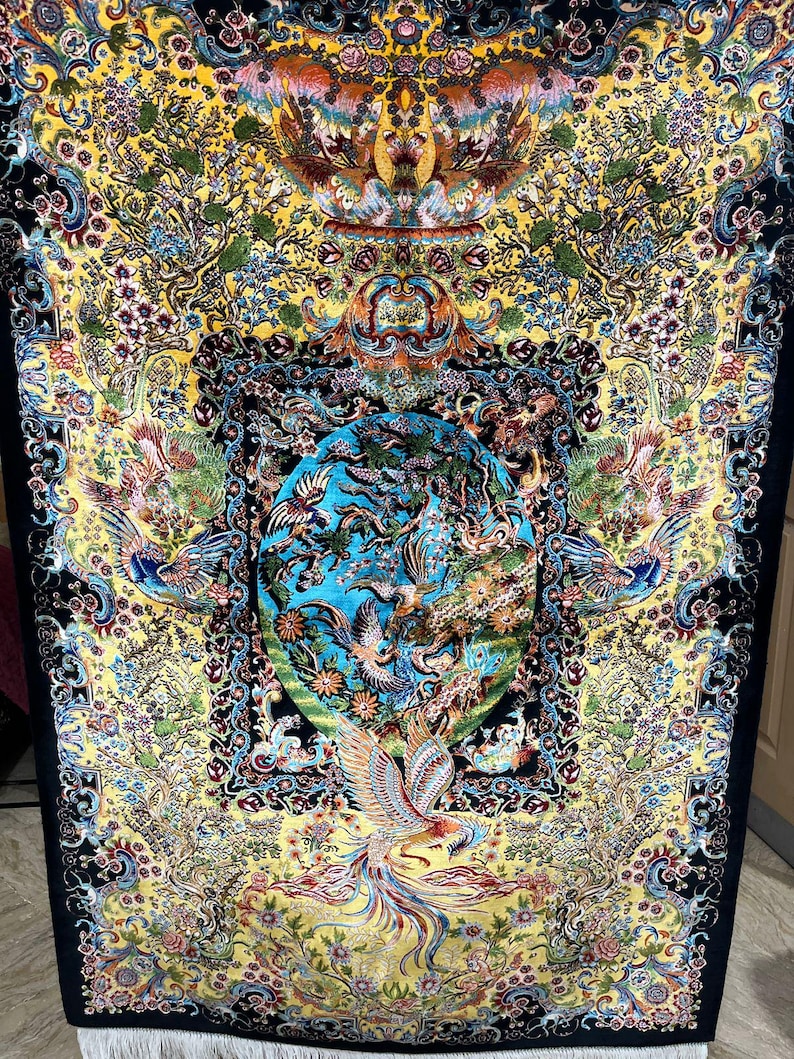 Persian silk rug with vibrant yellow Tabriz-style design featuring a mythical phoenix, intricate floral patterns, and traditional Oriental motifs. This 3x5 ft luxury carpet is ideal as wall art or floor decor. Made with fine silk for a soft texture and rich detail, perfect for adding warmth and elegance to living rooms, bedrooms, or gallery spaces. A beautiful blend of heritage and craftsmanship for art lovers and collectors.