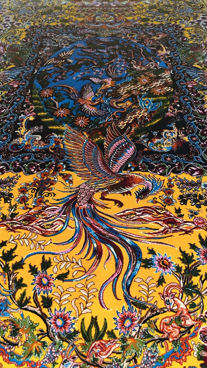 Stunning Persian silk rug in warm yellow tones, featuring a traditional Tabriz phoenix and floral motif. This 3x5 ft piece is ideal as a decorative carpet or wall art. Rich in detail and symbolism, it brings a luxurious, artistic touch to any interior space. Perfect for collectors, design lovers, or anyone wanting a bold, handcrafted statement piece rooted in Persian heritage.