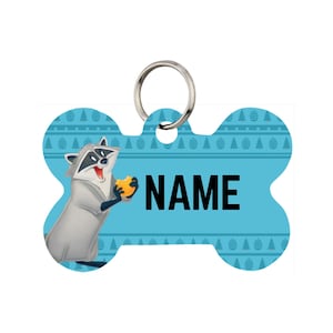 May include: A light blue, bone-shaped pet tag with a cartoon raccoon holding a yellow object. The tag has a silver ring for attachment and the word "NAME" in black. The tag is decorated with a pattern of trees and lines.