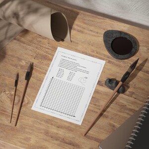 May include: A wooden desk with art supplies and a math worksheet. The worksheet has a graph and text. There are two paint brushes, a small ink well, a notebook, and a rolled-up piece of paper.