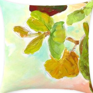 May include: Square throw pillow with a watercolor painting of green and yellow leaves on a branch. The background has soft pastel colors of light green, peach, and white. The pillow is square and has a soft, inviting appearance.