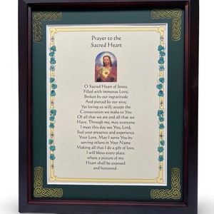 May include: A framed print with a green background and gold accents. The print features a prayer to the Sacred Heart of Jesus. The text reads: "O Sacred Heart of Jesus, Filled with immense Love; Broken by our ingratitude And pierced by our sins; Yet loving us still; accept the Consecration we make to You Of all that we are and all that we Have. Through me, may everyone I meet this day see You, Lord, Feel your presence and experience Your Love. May I serve You by serving others in Your Name Making all that I do a gift of love. I will bless every place where a picture of my Heart shall be exposed and honoured."