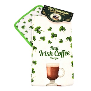 May include: A white kitchen towel and pot holder set with green shamrocks. The towel features a graphic of an Irish coffee and the text "Real Irish Coffee Recipe". The set includes a tag that reads "The Connemara Kitchen Collection".