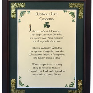 May include: A framed poem with a green background and gold trim. The poem is titled "Walking With Grandma" and is about the simple pleasures of spending time with a grandmother. The poem is written in a cursive font and is surrounded by shamrock designs.
