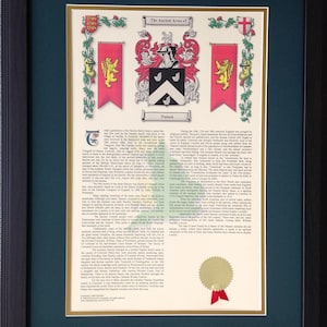 May include: Framed family crest artwork featuring the "Ancient Arms of Nanson." The crest is displayed in the center, flanked by banners with heraldic symbols. The artwork is set against a cream-colored background, framed in black, and includes a gold seal.