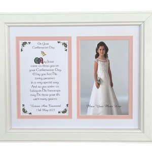 May include: White double photo frame with a Confirmation Day message and space for a photo. The frame has a white border and a pink matting. The text reads "On Your Confirmation Day" and a prayer.