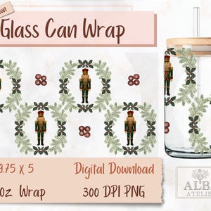 May include: A clear glass can wrap with a wooden lid and straw. The wrap features a repeating pattern of a nutcracker soldier within a green wreath, with brown berries. The text "Glass Can Wrap" is visible.
