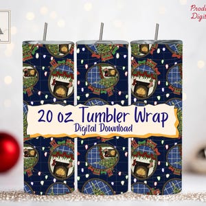 May include: Three 20 oz tumbler wraps with a navy blue background and a repeating pattern of a fireplace scene, Christmas lights, and ornaments. The text "20 oz Tumbler Wrap Digital Download" is displayed on a cream-colored banner.
