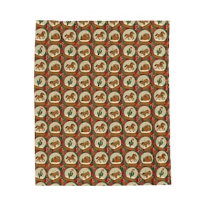May include: A repeating pattern on a fabric featuring snow globes, cacti, and horses. The snow globes contain a horse and a small tent. The background is a dark red with green and white accents.