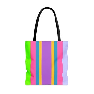 May include: A colorful tote bag with a vertical striped pattern. The stripes include neon green, hot pink, light blue, yellow, purple, and light purple. The bag has black handles.