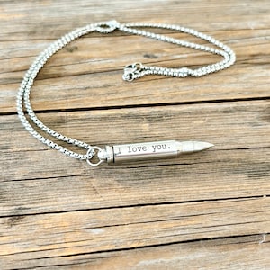 silver bullet urn necklace engraved with I Love you.