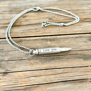 silver bullet urn necklace engraved with I Love you.