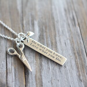 May include: Silver necklace with a charm that says "Do what you love, Love what you do." and a pair of scissors charm.