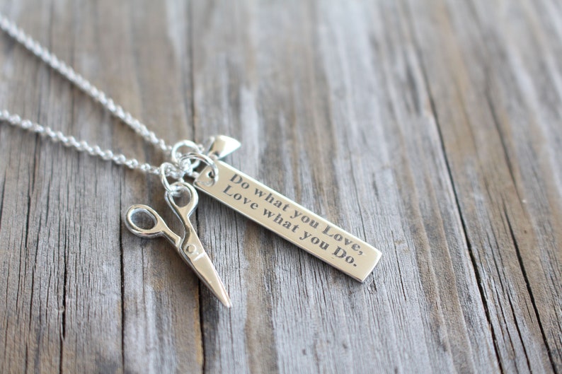 May include: Silver necklace with a charm that says "Do what you love, Love what you do." and a pair of scissors charm.