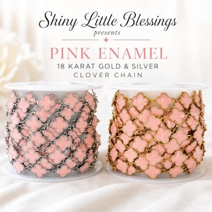 May include: Two spools of clover chain featuring pink enamel motifs. One spool has silver-toned metal links, and the other has 18 karat gold-toned metal links. Text reads: Shiny Little Blessings presents PINK ENAMEL 18 KARAT GOLD & SILVER CLOVER CHAIN.