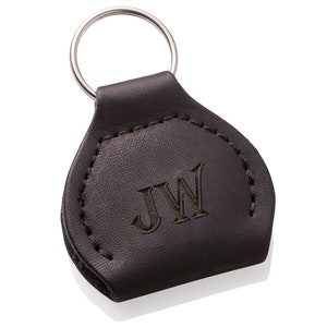 May include: Black leather keychain with a silver key ring and the initials "JW" embossed on the front.