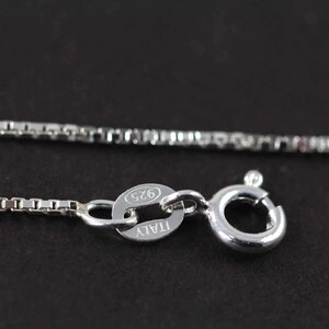 May include: A silver chain necklace with a lobster clasp and a tag that reads "ITALY 925".