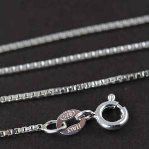 May include: A silver chain necklace with a lobster clasp and a tag that reads "ITALY 925".