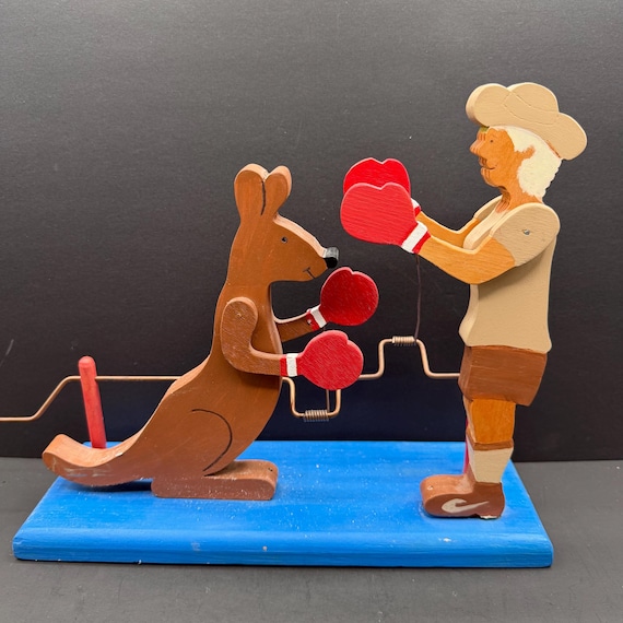 A hand-cranked Mexican folk art automaton where a kangaroo actually boxes — painted in vivid retro style by a real craftsperson, zero chance your friend has one.