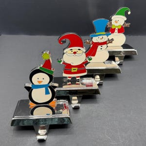 Vintage julstrumphållare set med 4 metalltomte snögubbe pingvin