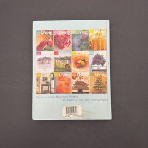 May include: A light blue book with multiple magazine covers featuring the word "Living" and various images. The book contains more than 500 recipes and 96 pages of full-color photographs.