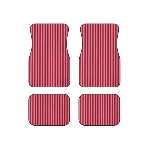 May include: A set of four car floor mats featuring a vertical striped pattern in alternating shades of dark red and light pink. The set includes two larger front mats with contoured top edges and two smaller rectangular rear floor mats.