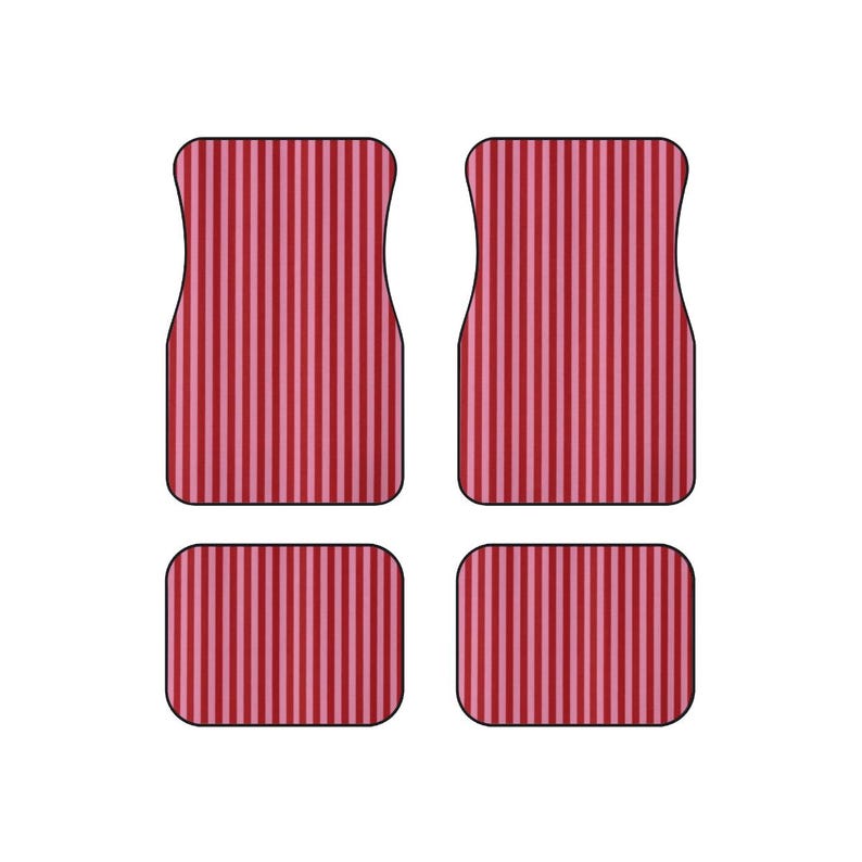 May include: A set of four car floor mats featuring a vertical striped pattern in alternating shades of dark red and light pink. The set includes two larger front mats with contoured top edges and two smaller rectangular rear floor mats.