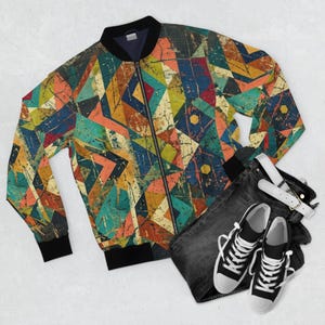 May include: A vibrant bomber jacket featuring a geometric design in blue, orange, green, and yellow. The jacket has a black collar, cuffs, and zip. Accompanied by black jeans, a white belt, and black and white trainers.