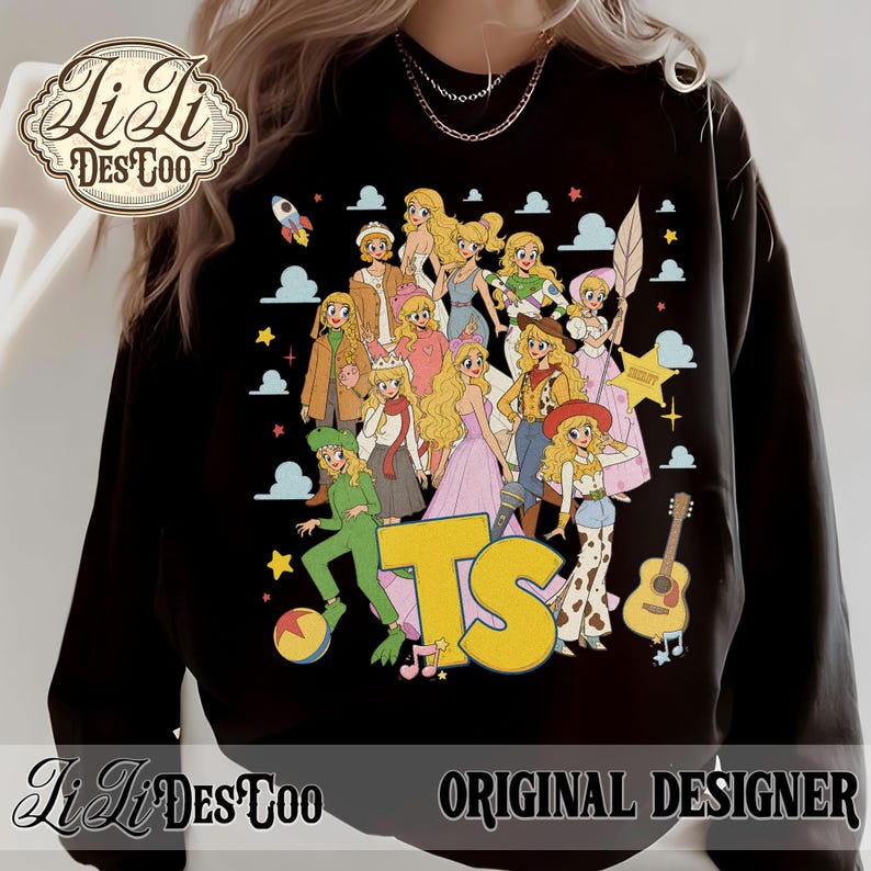 May include: A black long-sleeve sweatshirt featuring a graphic print of multiple blonde characters in various outfits, including a green alien costume, a cowgirl outfit, and a space ranger suit. The text TS is printed in large yellow letters.