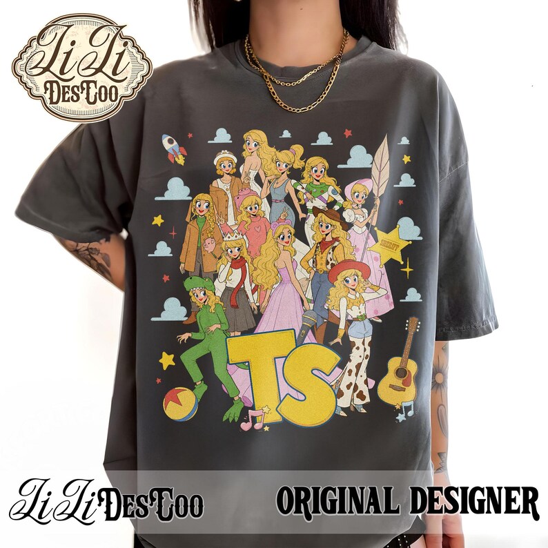 May include: A charcoal gray short-sleeve t-shirt featuring a large graphic print of multiple blonde characters in various outfits, including a green alien costume, a cowboy hat, and a pink dress, with the yellow letters TS and a guitar.