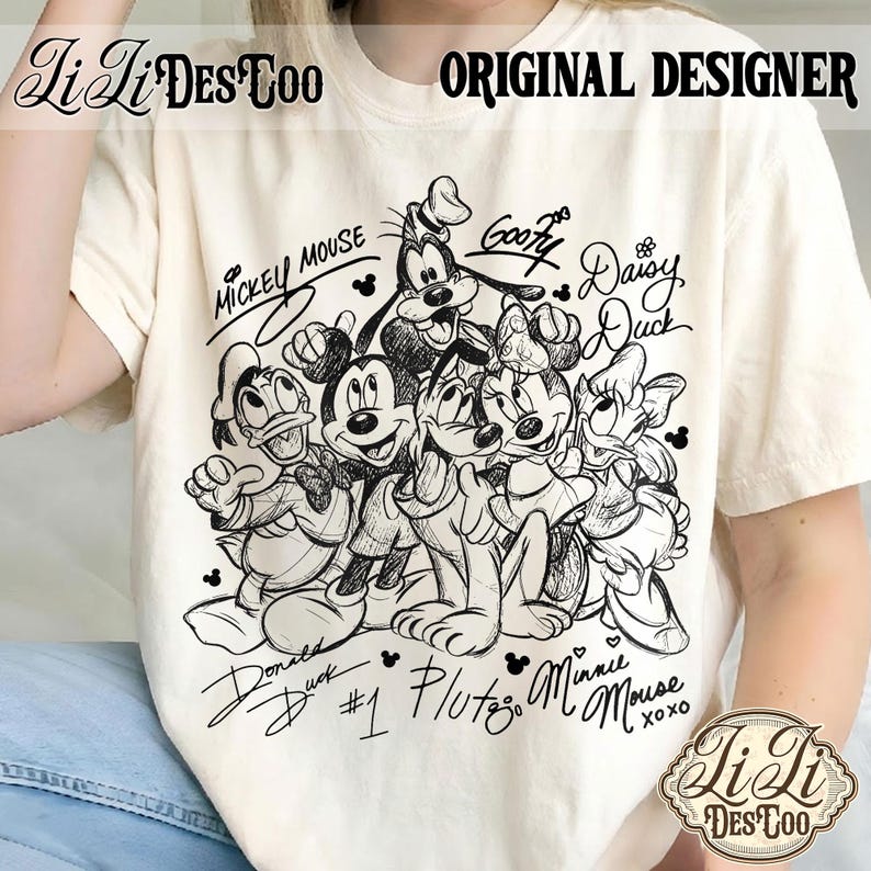 May include: Cream-colored t-shirt featuring a black and white sketch of Disney characters Mickey Mouse, Minnie Mouse, Donald Duck, Daisy Duck, Goofy, and Pluto. The shirt includes the text "Mickey Mouse", "Goofy", "Daisy Duck", "Donald Duck", "Pluto", and "Minnie Mouse".