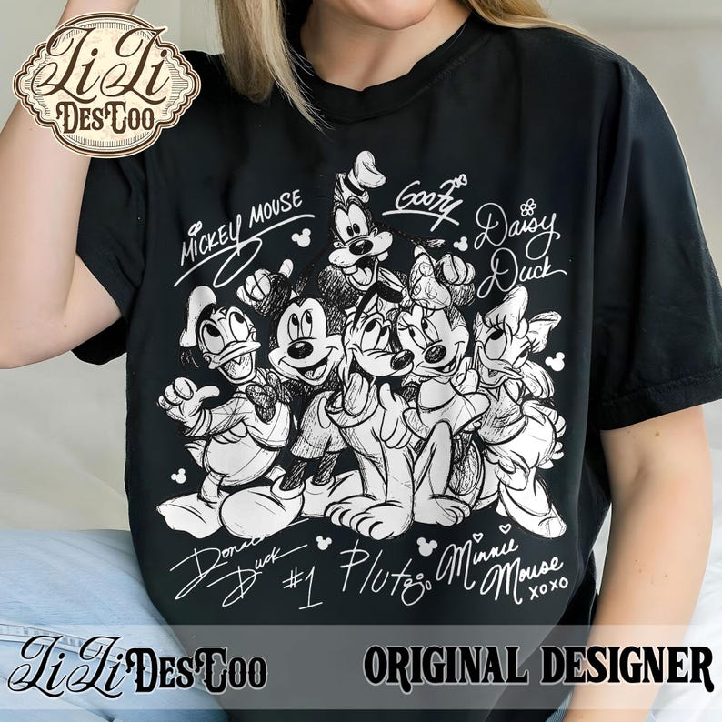 May include: Black t-shirt featuring a group of Disney characters, including Mickey Mouse, Goofy, and Donald Duck, in a black and white sketch design. The names of the characters are written above and below them. The shirt also has the text "Original Designer".