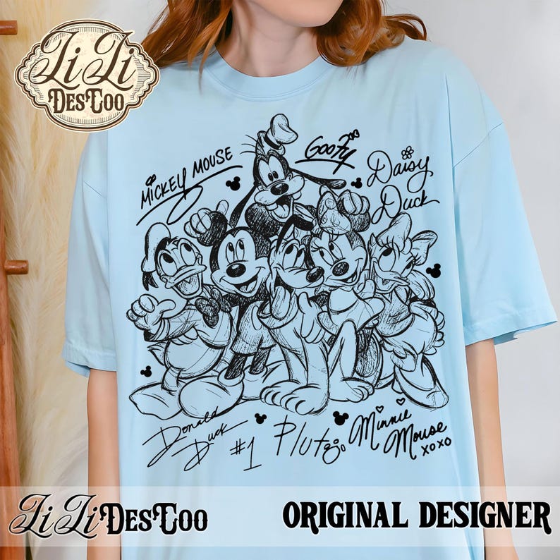 May include: Light blue t-shirt featuring a black and white sketch of Mickey Mouse, Minnie Mouse, Donald Duck, Daisy Duck, Goofy, and Pluto. The shirt includes the characters' signatures and the text "Original Designer."