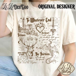 May include: Cream-colored t-shirt with a brown graphic design featuring a castle, deer, dragon, sword, and text. The text includes "To Whatever End," "Terrasen," and "The Thirteen." The shirt also has the text "Original Designer" and the brand name.